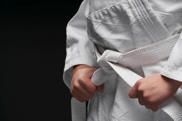 Hands closeup - teenager dressed in martial arts clothing posing on a dark gray background, a sports concept — 스톡 사진