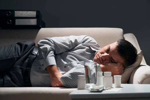 Overworked Businessman Lying Sofa Resting Pills Glass Water Him — Stock Photo, Image