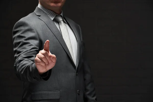 Businessman Portrait Pointing Forefinger Dressed Gray Suit Dark Wall Background — Stock Photo, Image