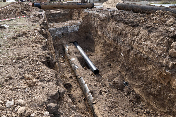repair and replacement main pipeline of heating systems, district heating pipes network, water supply or Sewerage in city, removing old pipes and replacing them with new ones in a hole in the ground