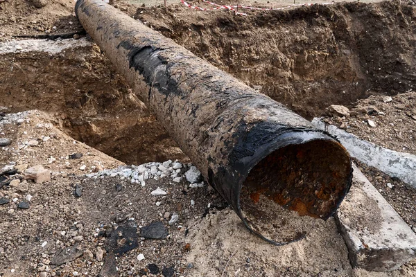 都市の暖房装置 地区暖房管網 給水又は下水道の修理及び交換 旧管の撤去及び地上の穴の中の新しい管への交換 — ストック写真