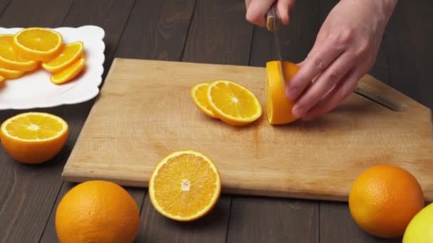 Slicing Orange Kitchen Cutting Board Putting Plate Wooden Table Background — Stock Video