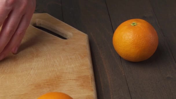 Slicing Orange Kitchen Cutting Board Wooden Table Background Close View — Stock Video