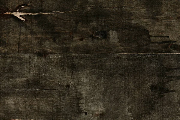 abstract black painting on a wood background, painting in grunge style, dark painting on a plywood