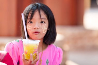 Thai little girl holding soda clipart