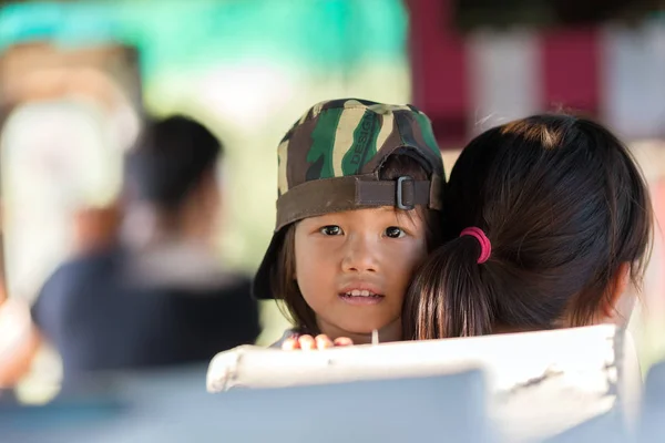 Thai little girl in mother 's arms — стоковое фото