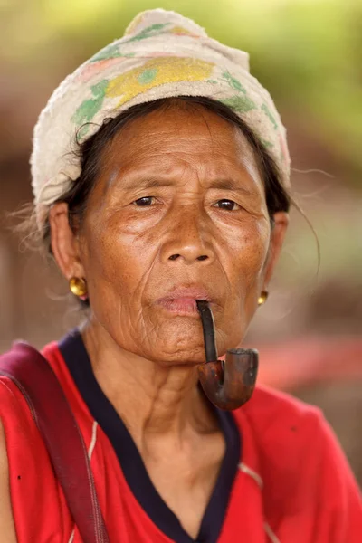 Karen tribe woman smoking pipe