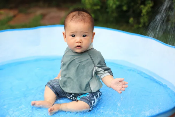 Happy son baby in inflatable pool — Stock Photo, Image