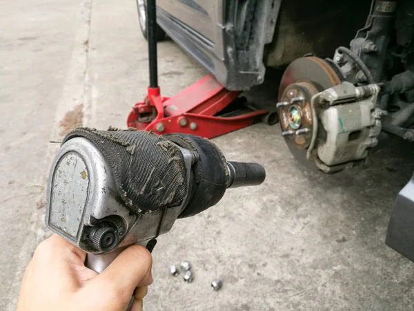 Screwing mechanic on hand, garage — Stock Photo, Image