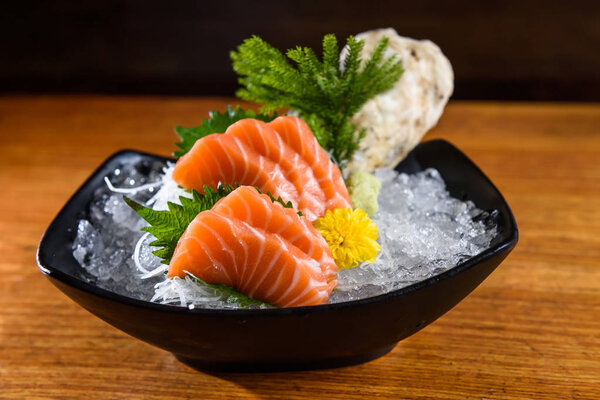 Fresh salmon sashimi on wooden table
