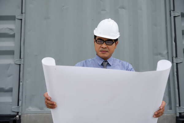 Engineer manager look at consturction paper plan