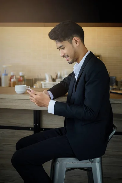 businessman using smartphone at coffee shop