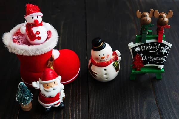 Christmas decorations on black wood — Stock Photo, Image