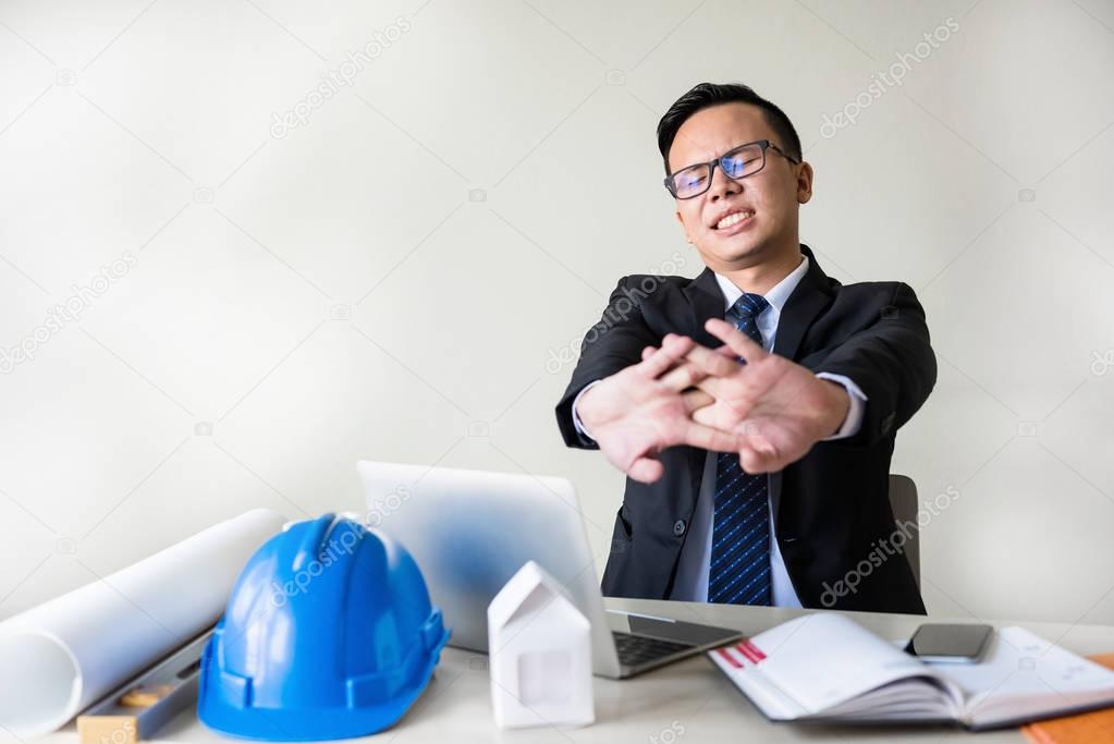 Painful Businessman stretch arms and hands 
