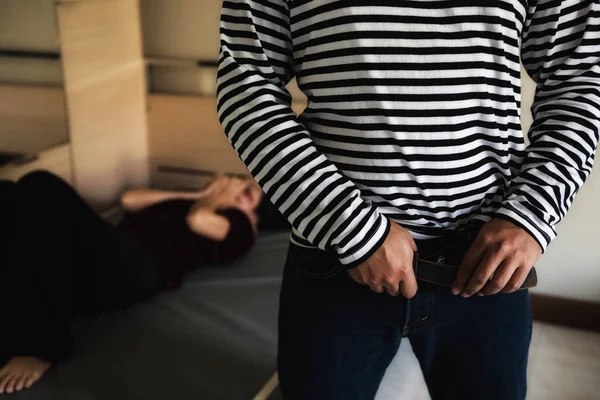 Man wear belt and jeans after raping — Stock Photo, Image