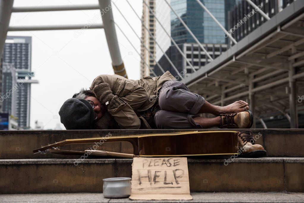 beggar or Homeless man sleep in city at winter