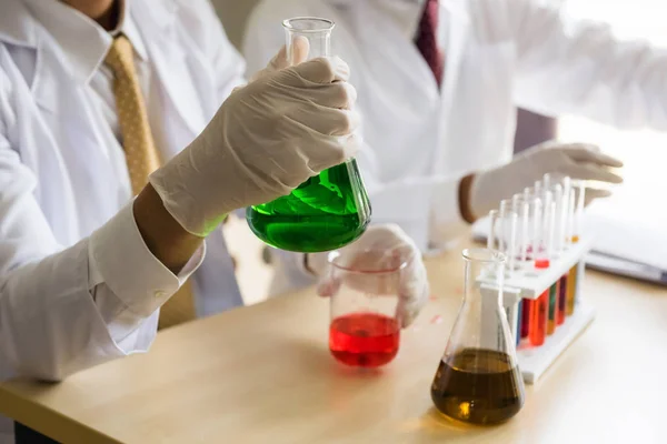 Male scientist test color chemical liquid