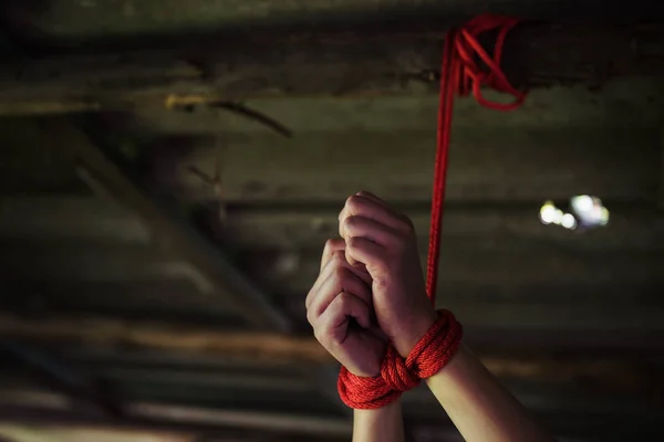 Closeup hostage hands tied by red rope — Stock Photo, Image