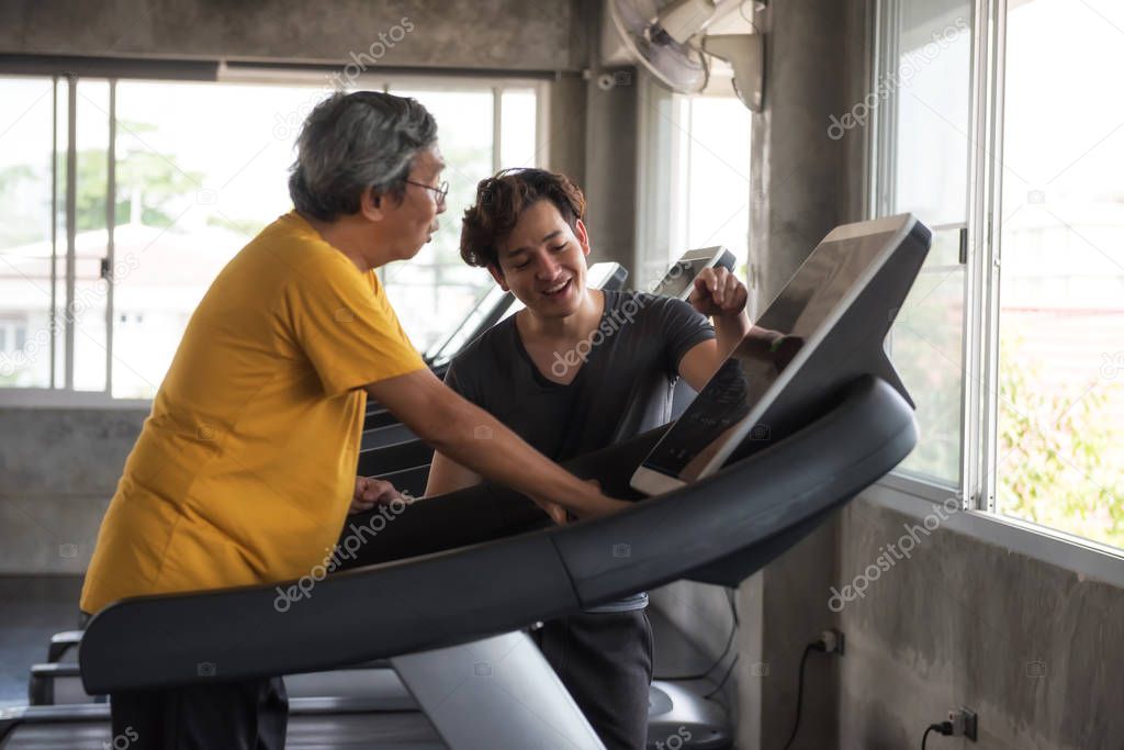 Old man cadio on treadmill with trainer