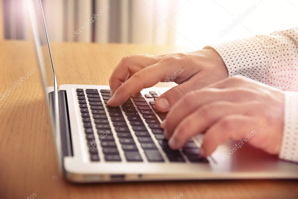 Man's hands typing on laptop keyboard. Concept for background, website banner, poster, presentation templates, social media, advertising and printed materials. 