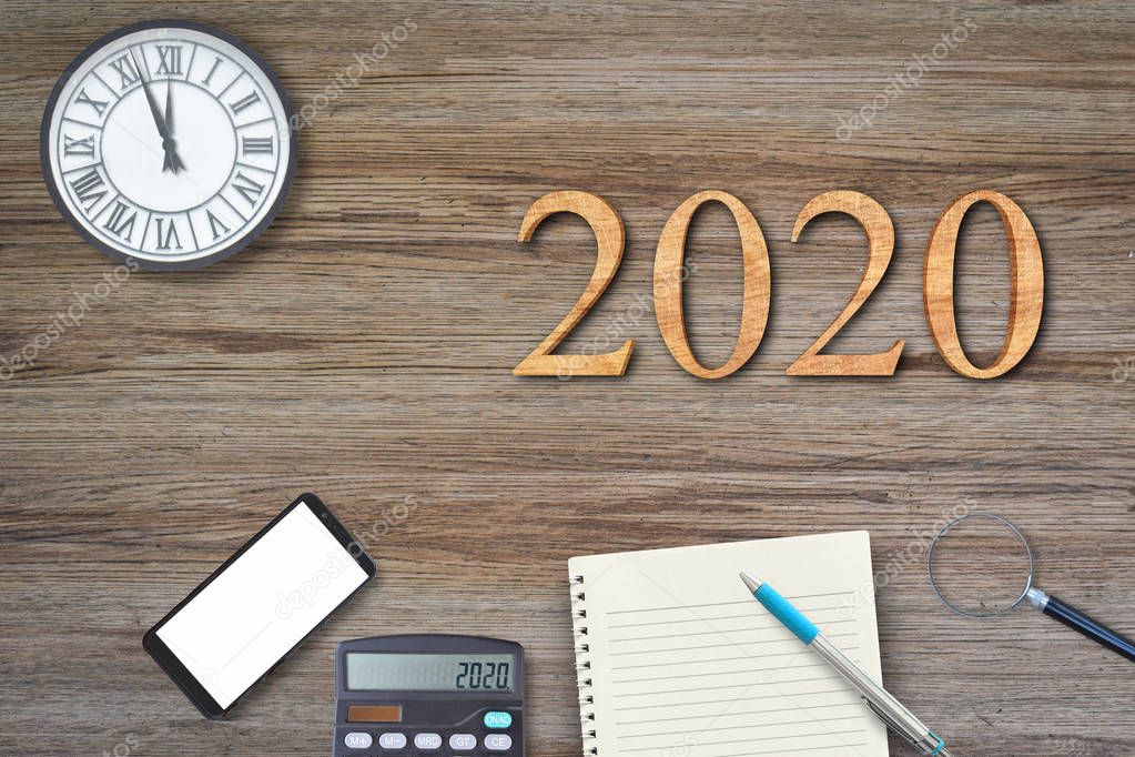 2020 text number on wood background with office accessories. Business concepts ideas.