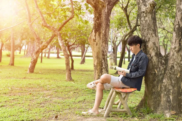 Der Junge Mann Sitzt Entspannt Park Und Liest Ein Buch — Stockfoto