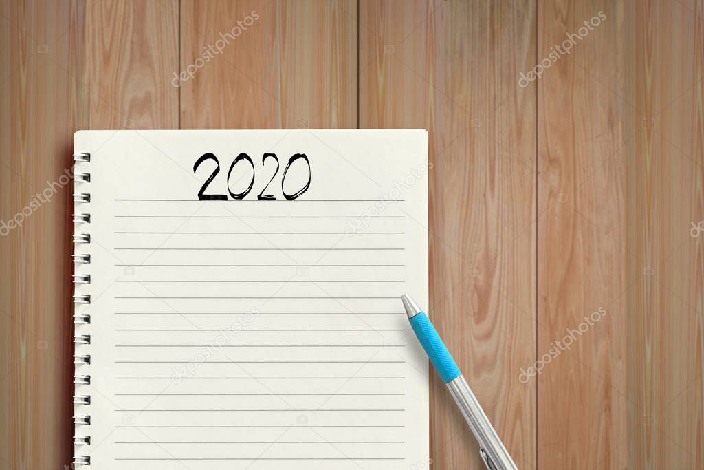 2020 Handwriting text in notepad on table - business concept.
