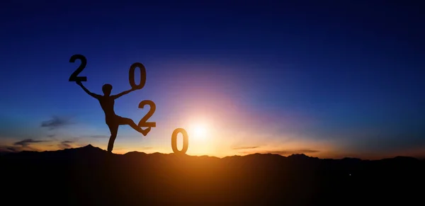 Silhouette des Menschen beim Gehen auf dem Hügel und 2020 Jahre, während cel — Stockfoto