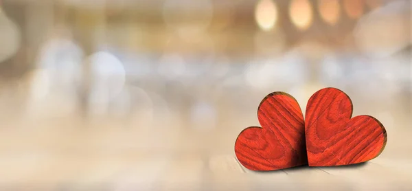 Red heart on wooden table against defocused lights, valentine day greeting card. Bokeh background.