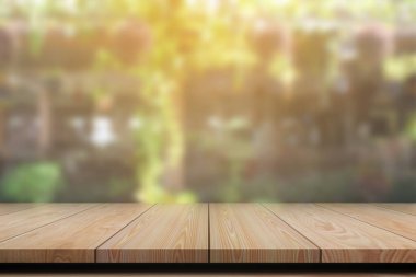 Empty wooden table with blurred background for product display.