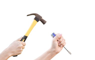 Male hands working with old rusty hammer and flat screwdriver isolated on white background with clipping path.