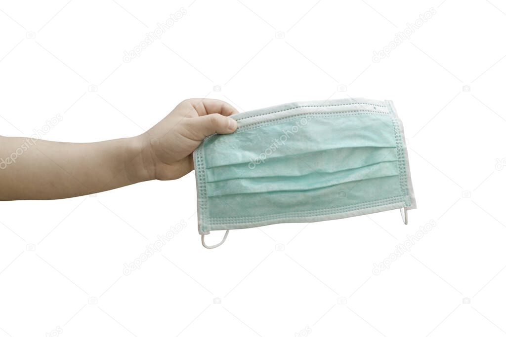 Child hand holding medical mask isolated on white background. Object with clipping path