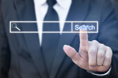 İş adamı sanal ekranda internet arama sayfasına tıklıyor. Arama kavramı düğmeye basılı.
