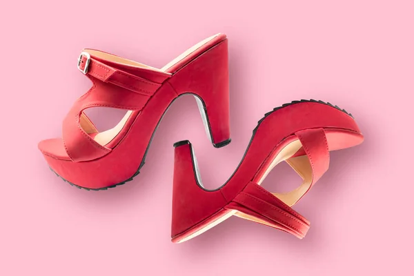 Red shoes high heels isolated on a pink background. Object with clipping path.