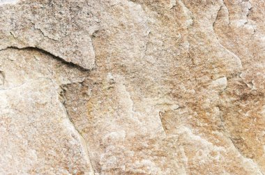 Çatlak kahverengi bir taşın dokusu.