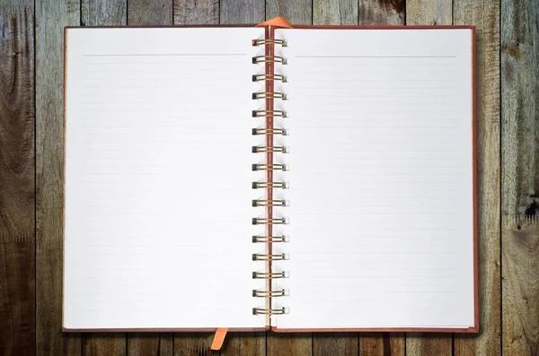 Note book on panel wood background