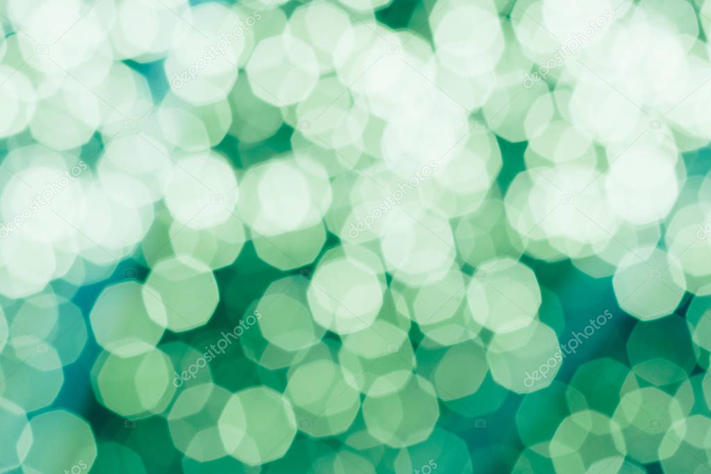 Green Background with Blurred multiple of white Bokeh during Christmas and New Year Event