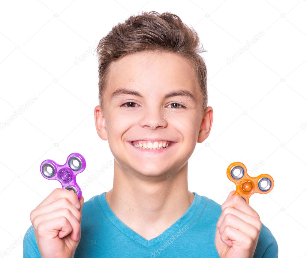 Teen boy with spinner on white