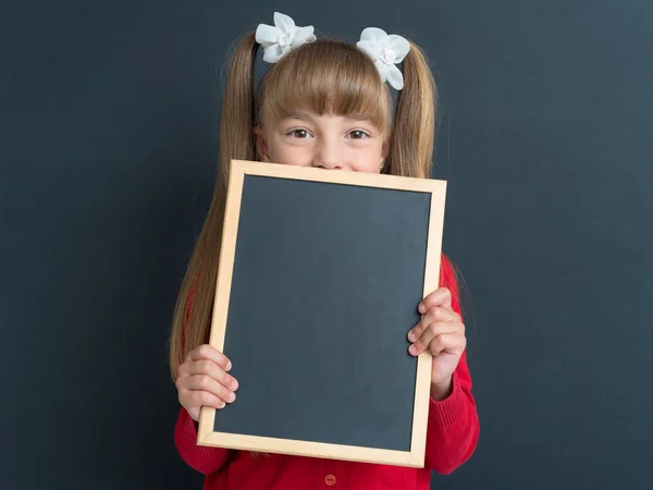 Little girl with small blackboard — Stock Photo, Image