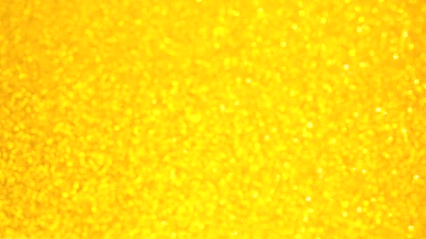 Διακοσμητικό defocused αφηρημένο χρυσό φόντο με αφρώδη λάμψη. Εορταστικό και εορταστικό υπόβαθρο για κείμενο. 4k πλάνα — Αρχείο Βίντεο