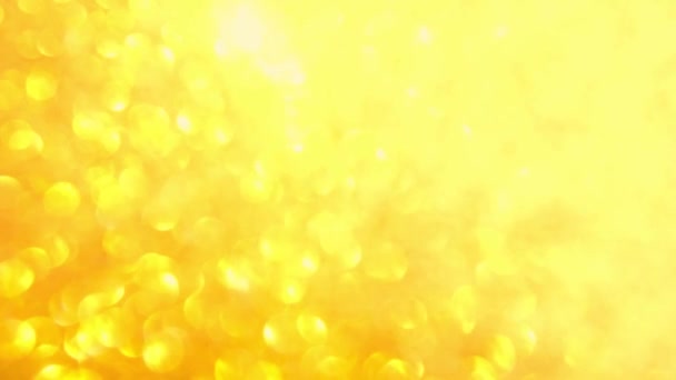 Decorative defocused abstract gold background with sparkling glitter. Festive and holiday background for text. 4k footage — Stock Video