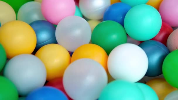 Multi coloured plastic balls in big dry paddling pool in playing centre close up. playroom. Toys. Leisure Activity — Stock Video