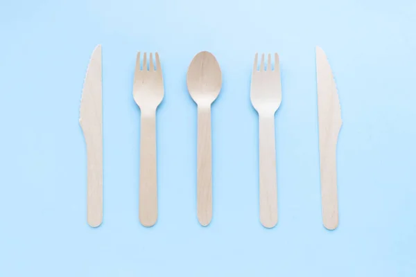 Eco friendly disposable kitchenware utensils on blue background. wooden forks and spoons. ecology, zero waste concept. top view. flat lay — Stock Photo, Image