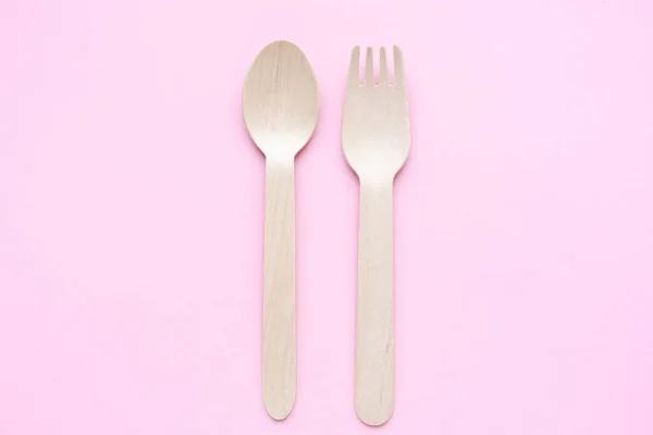 Eco friendly disposable kitchenware utensils on pink background. wooden forks and spoons. ecology, zero waste concept. top view. flat lay — Stock Photo, Image