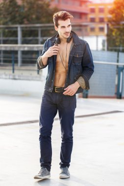 Seksi genç adam ile kulaklıklar açık yürüyüş