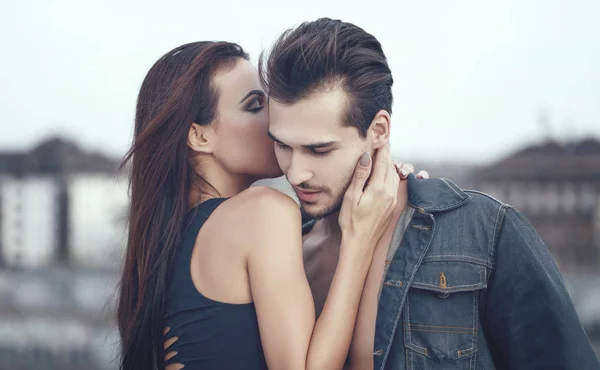 Young woman whispering love into boyfriend ear — Stock Photo, Image