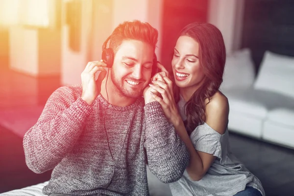 Young couple listening music indoor