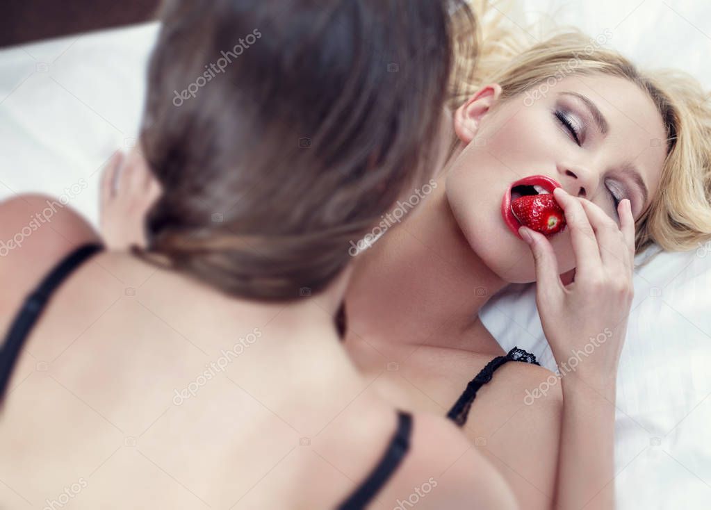 Sexy lesbian lovers eating strawberry in bed book cover template