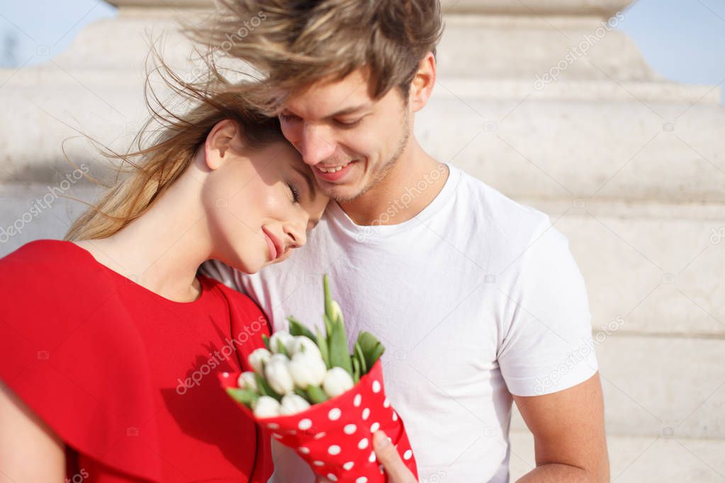 Young woman in red dress cuddle to man while dating, dream about