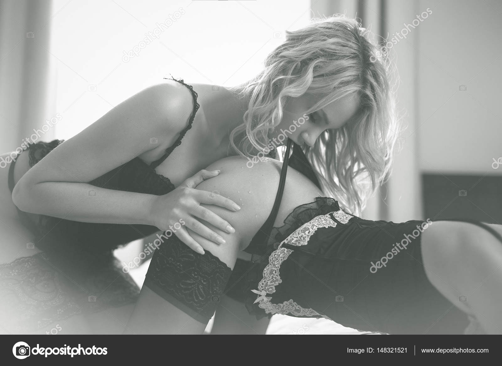 Sexy lesbian couple foreplay in bed, black and white Stock Photo by  ©sakkmesterke 148321521